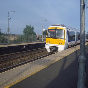 168 005 pauses at Warwick Parkway with a train for Marylebone.