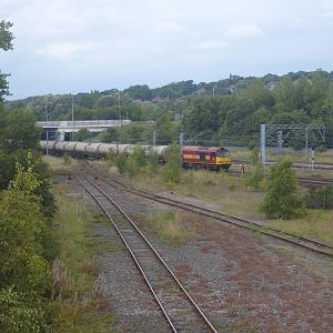 60065 pauses at the entrance to the yard with oil tanks from Jarrow as its driver sets the points.