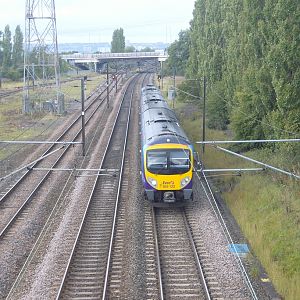 185 132 passes the northern end of the yard with a Newcastle - Manchester Airport service.