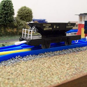 Dogfish ballast wagon. 
This is a Cambrian, OO gauge body and a Lima, Seacow fence, combined with a Tomy chassis.